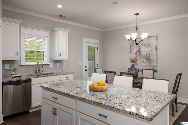 kitchen with sink, white cabinetry, a center island, tasteful backsplash, and stainless steel dishwasher