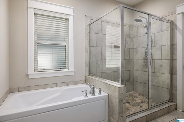 bathroom featuring tile patterned floors and independent shower and bath