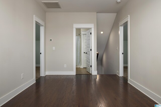 unfurnished bedroom featuring dark wood-type flooring