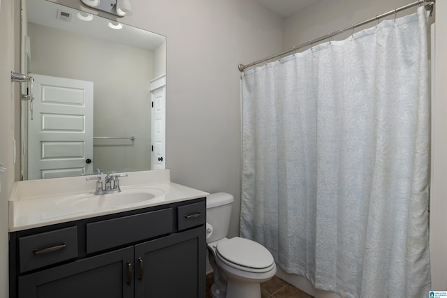 bathroom featuring vanity, toilet, and tile patterned flooring