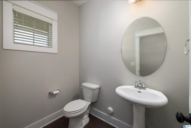 bathroom featuring hardwood / wood-style flooring, sink, and toilet