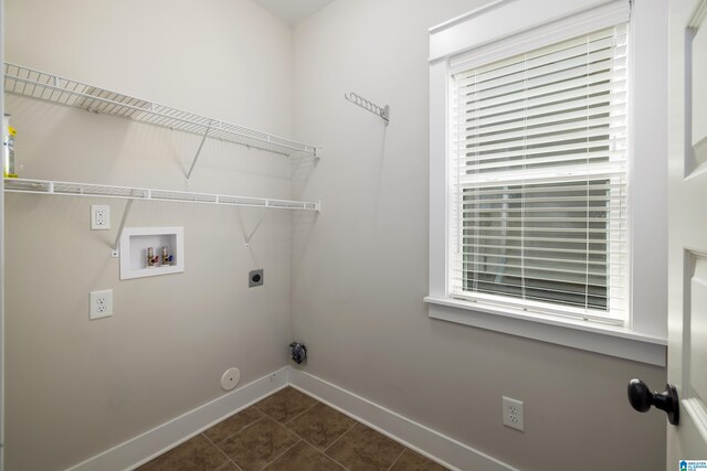 clothes washing area with electric dryer hookup, gas dryer hookup, dark tile patterned floors, and washer hookup