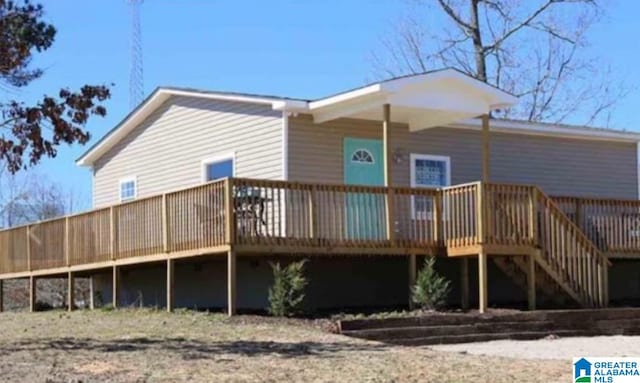 back of house featuring a wooden deck