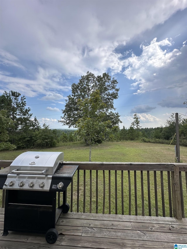 wooden deck featuring a yard and grilling area