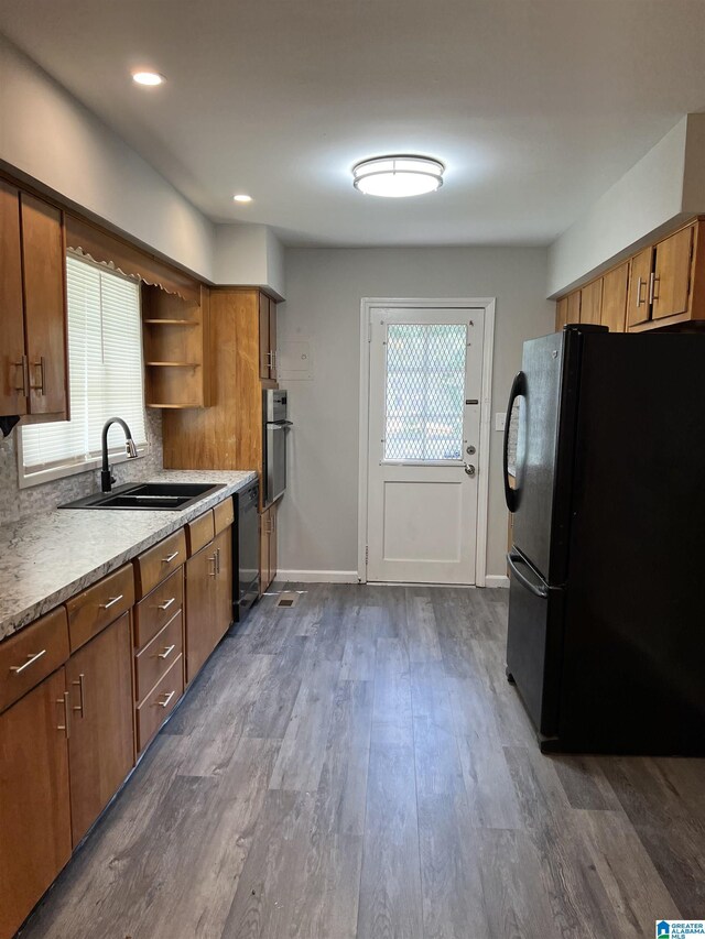 kitchen featuring dark hardwood / wood-style floors, sink, and black appliances