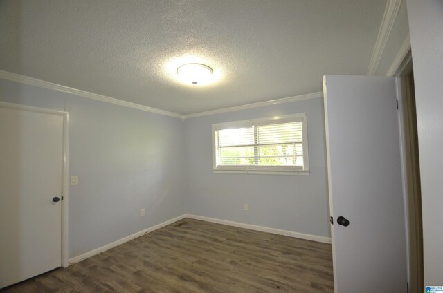 interior space with crown molding, a textured ceiling, sink, washer / dryer, and tile patterned floors