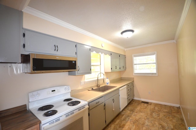 kitchen featuring light tile patterned flooring, ornamental molding, white appliances, and sink