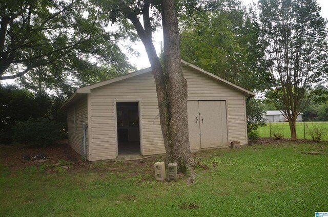 view of outbuilding with a lawn