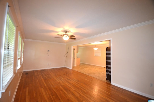 spare room with ornamental molding, tile patterned flooring, and ceiling fan