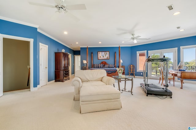 interior space featuring crown molding, light colored carpet, and ceiling fan