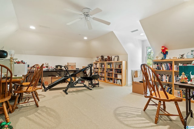 interior space featuring lofted ceiling, light carpet, and ceiling fan