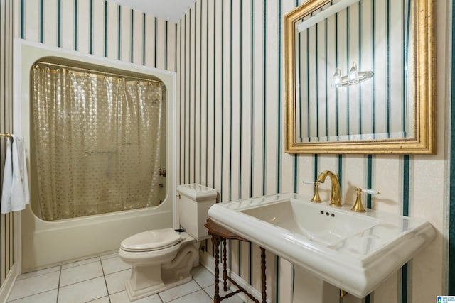 full bathroom featuring toilet, sink, tile patterned floors, and shower / bath combo with shower curtain