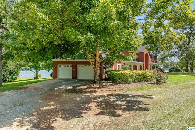 view of property hidden behind natural elements featuring a garage