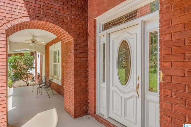 entrance to property featuring ceiling fan