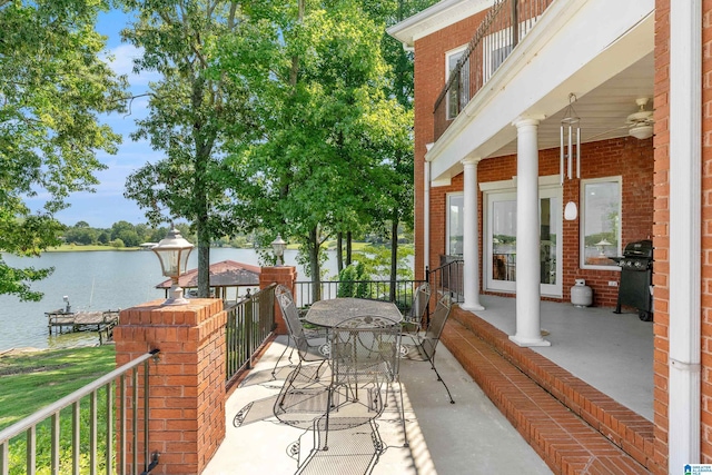 view of patio featuring a water view and grilling area