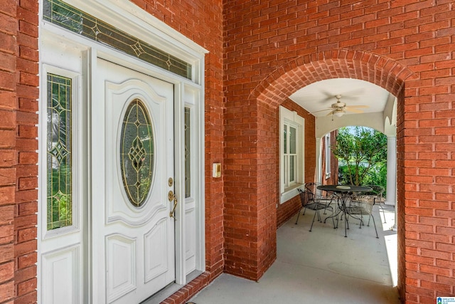 view of exterior entry featuring ceiling fan