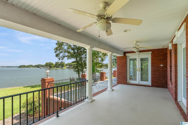 view of patio with a water view, ceiling fan, and french doors