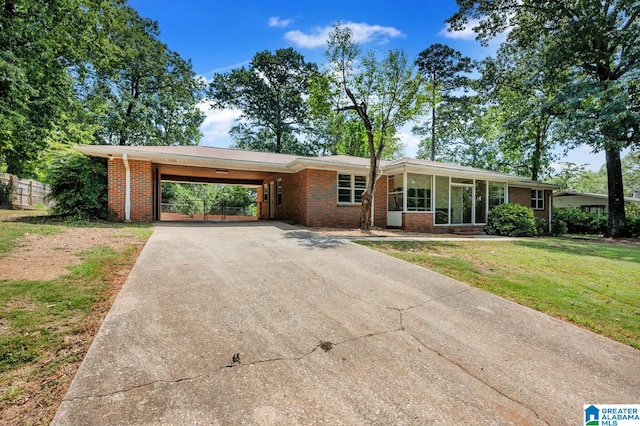 single story home featuring a carport and a front yard