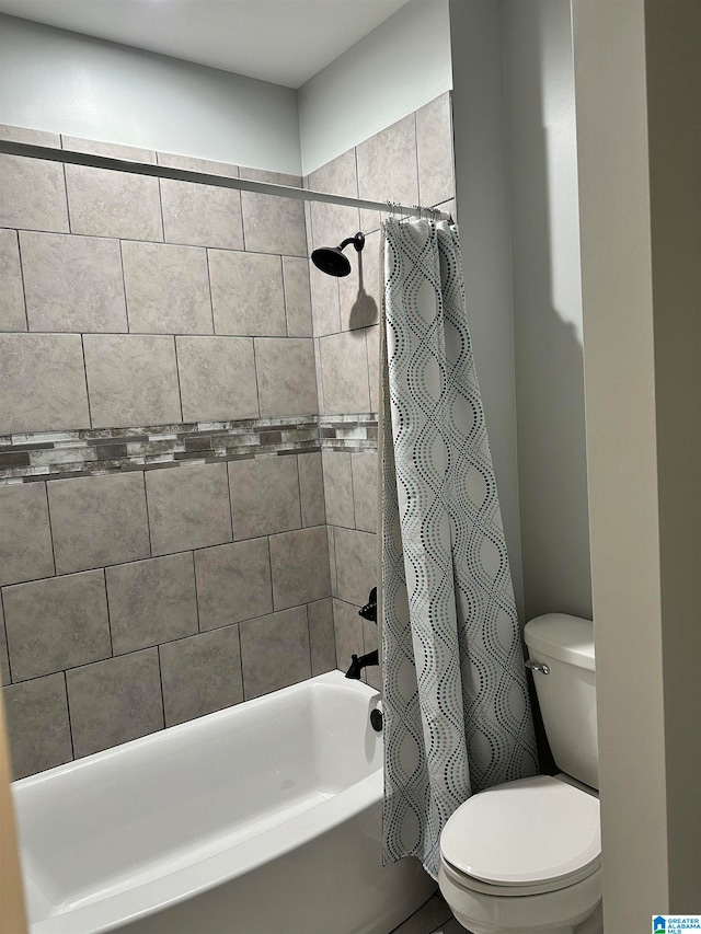 bathroom with toilet and shower / tub combo with curtain