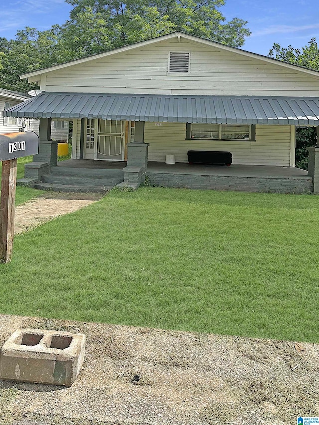 view of front of house with a porch and a front lawn