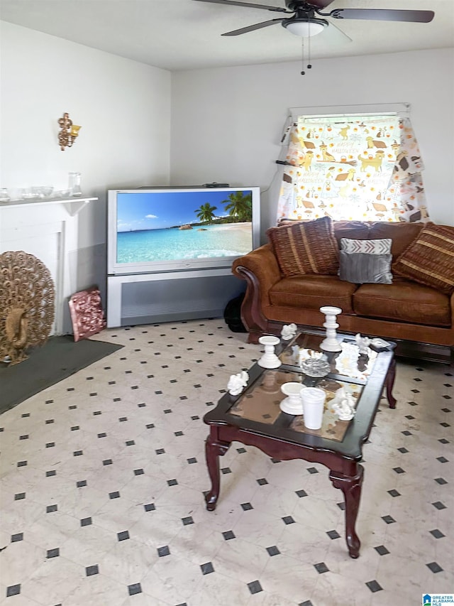 living area with tile patterned floors and ceiling fan