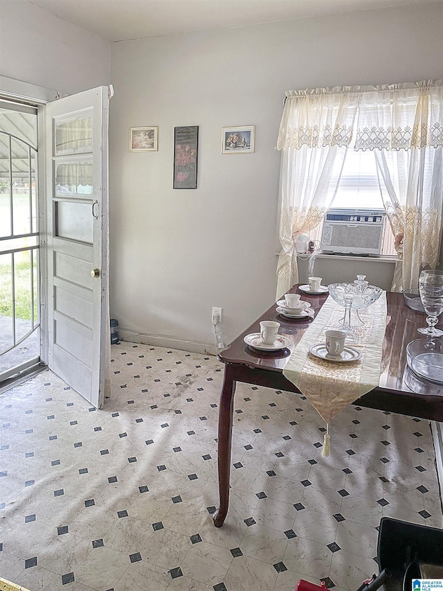 dining room featuring cooling unit and baseboards