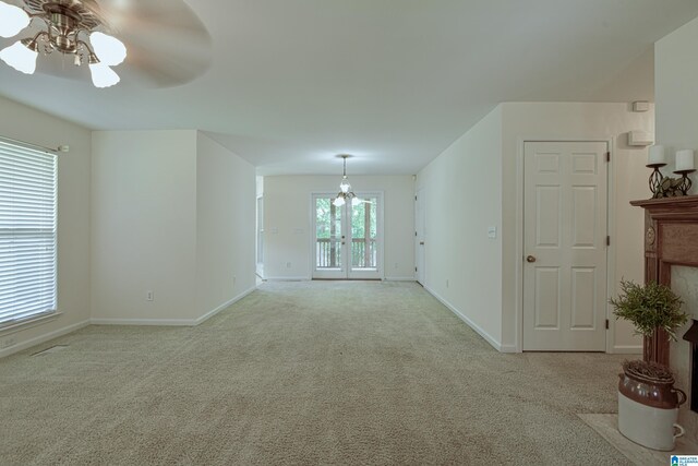 interior space with ceiling fan and light carpet