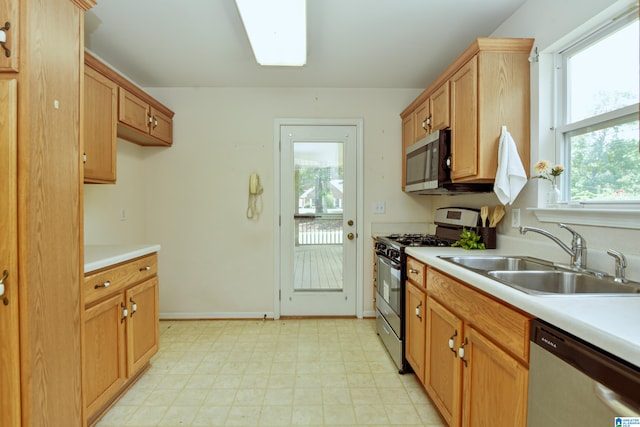 kitchen with sink, stainless steel appliances, and light tile patterned flooring