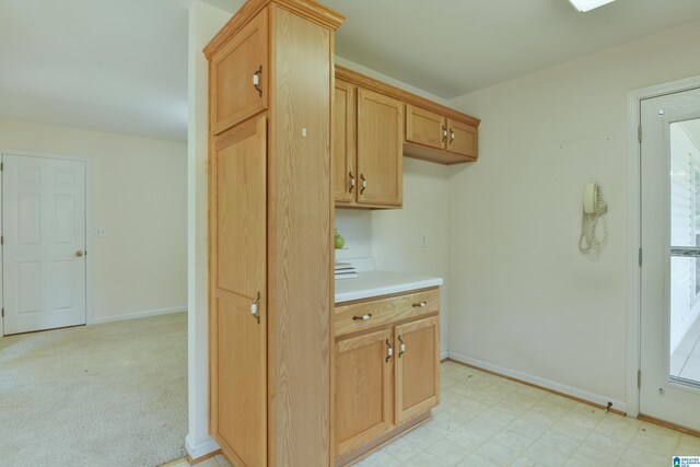 kitchen with plenty of natural light and light colored carpet