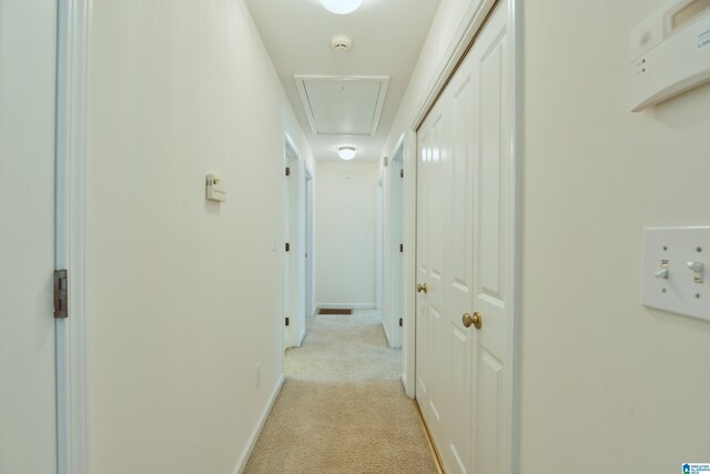 hall featuring light colored carpet