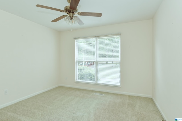 carpeted spare room with ceiling fan and a healthy amount of sunlight