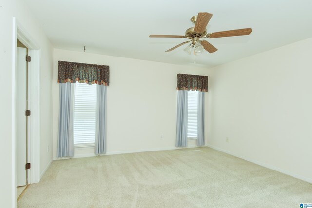 carpeted spare room with ceiling fan