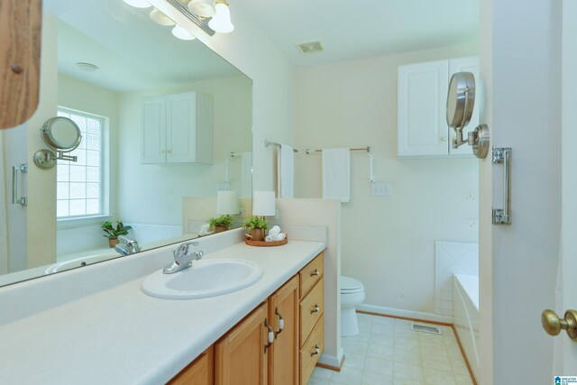 bathroom with toilet, tile patterned floors, a bathing tub, and vanity