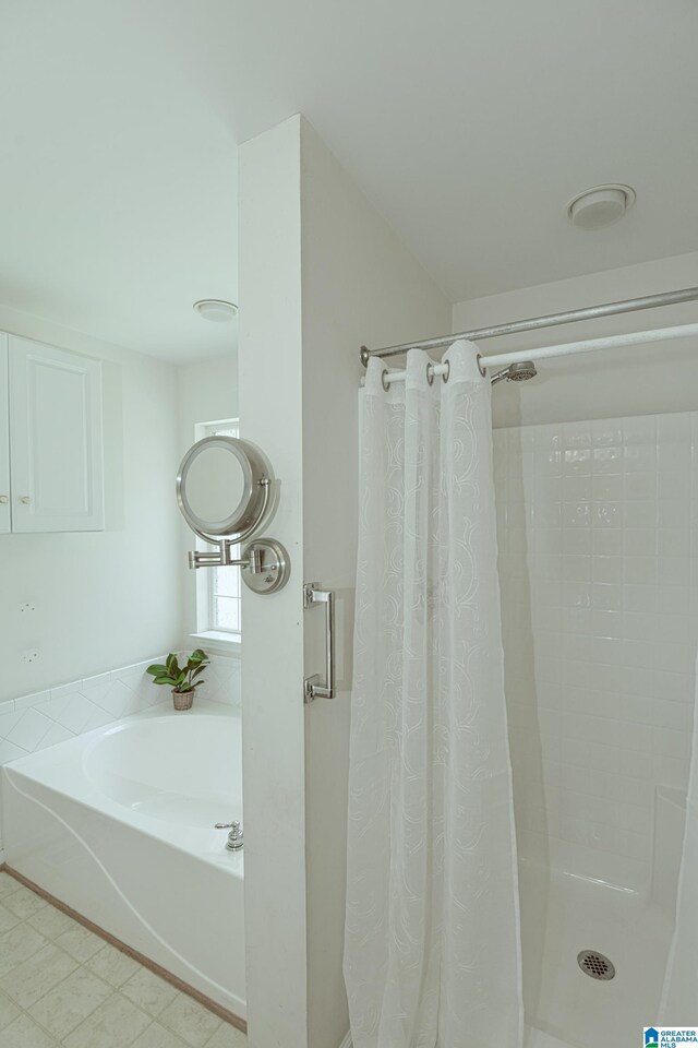 bathroom with tile patterned floors and independent shower and bath