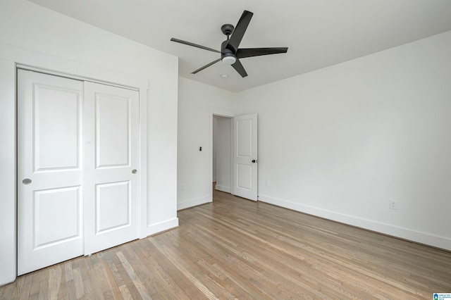 unfurnished bedroom featuring a closet, ceiling fan, and light wood-type flooring