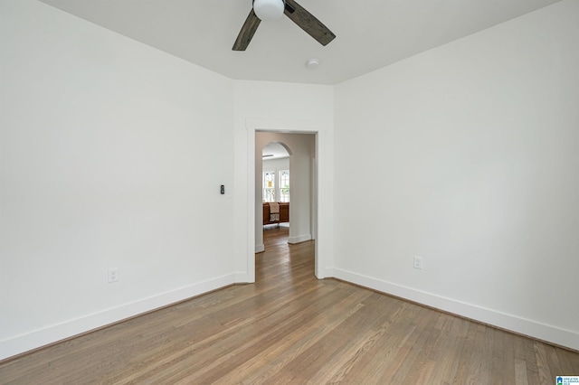 spare room with ceiling fan and light wood-type flooring