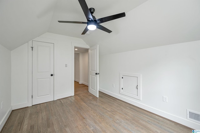 bonus room with ceiling fan, vaulted ceiling, and light wood-type flooring