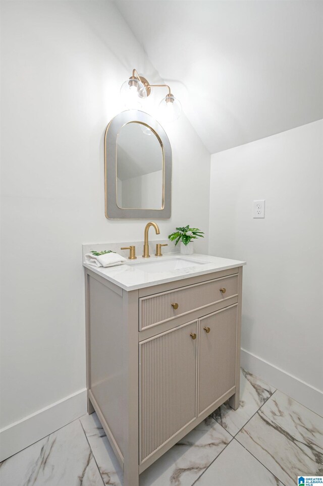 bathroom featuring vaulted ceiling, vanity, and tile patterned floors