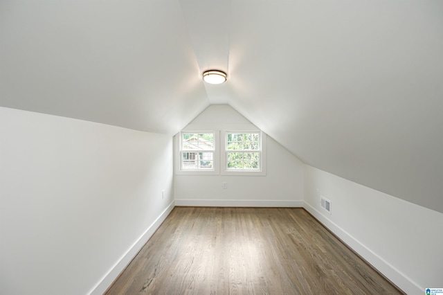 bonus room featuring vaulted ceiling and hardwood / wood-style flooring