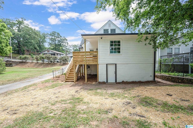 back of property with a wooden deck