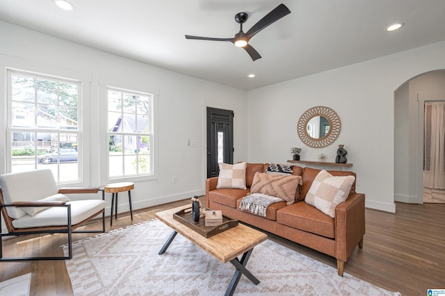 living room with wood-type flooring and ceiling fan