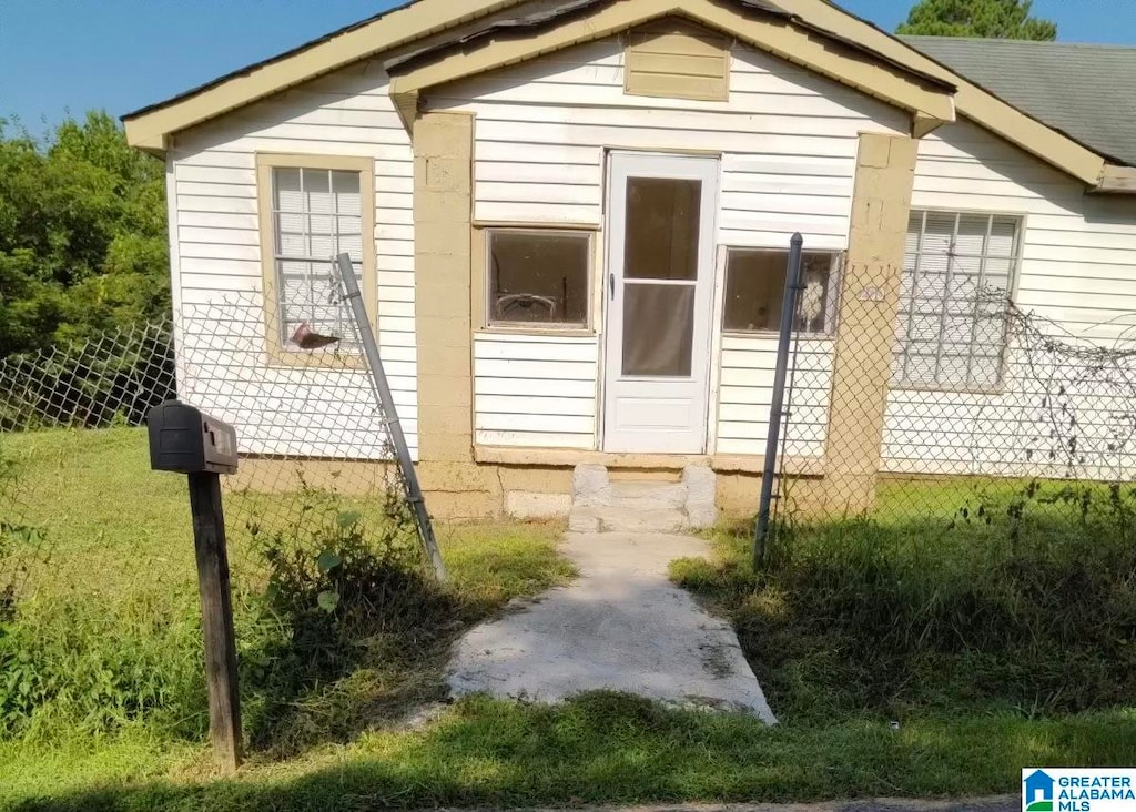 view of side of property with a lawn