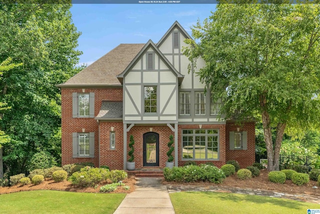 tudor home featuring a front yard