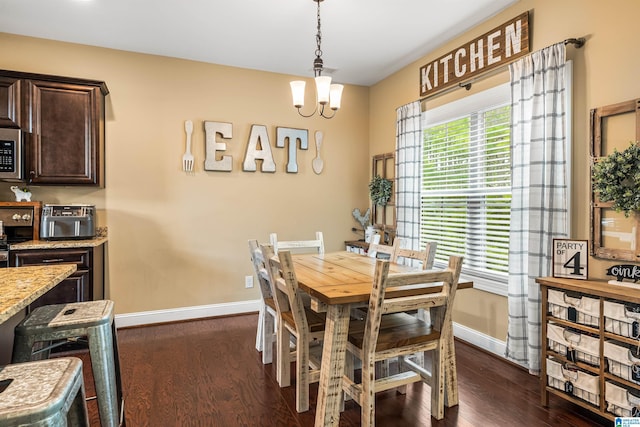 dining area featuring baseboards, an inviting chandelier, and dark wood-style flooring