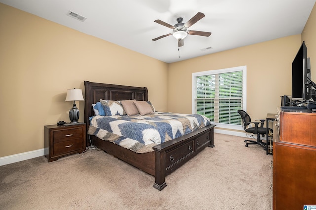 bedroom with visible vents, light colored carpet, and baseboards