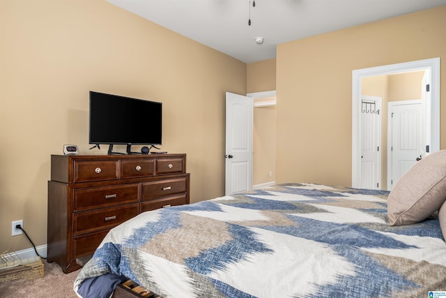 carpeted bedroom featuring baseboards