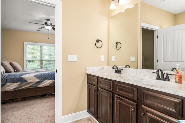 ensuite bathroom with ceiling fan, double vanity, ensuite bathroom, and a sink