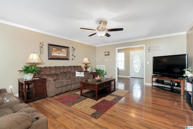 living room featuring hardwood / wood-style flooring, crown molding, and ceiling fan