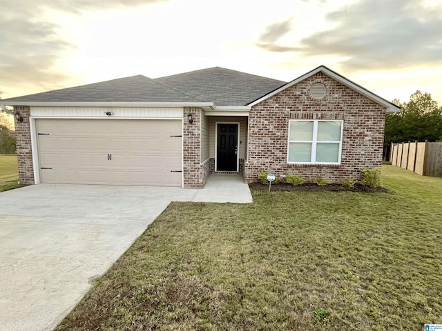 single story home with a garage and a lawn