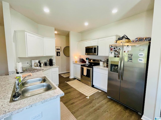 kitchen with white cabinets, sink, appliances with stainless steel finishes, and dark wood-type flooring